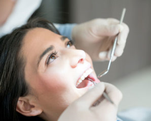 a young woman gets her teeth cleaned at a dental clinic
