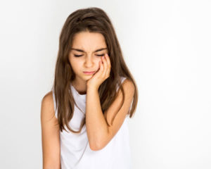 a young girl has a toothache