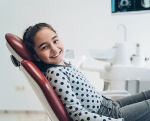 a happy kid in a dentist chair