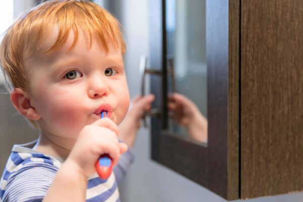 kid is brushing his teeth