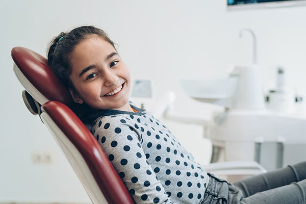 a happy kid in a dentist chair